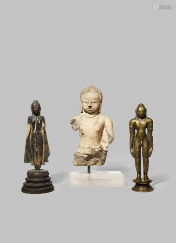 THREE FIGURES OF BUDDHA C.8TH CENTURY AND LATER Comprising: a carved stone torso, a standing wood