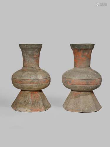 A PAIR OF CHINESE POTTERY VASES HAN DYNASTY 206BC - 220AD With bulbous bodies decorated with earth