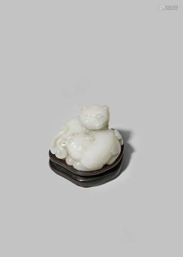 A CHINESE WHITE JADE CARVING OF TWO LION DOG PUPPIES QING DYNASTY Recumbent, huddled together and