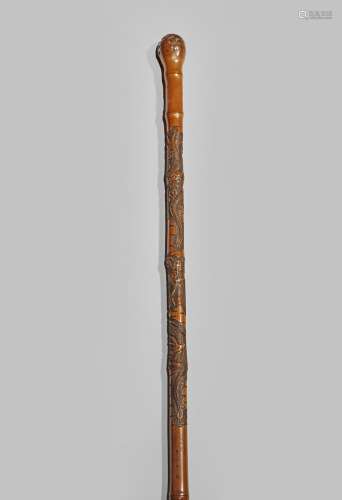 A JAPANESE BAMBOO WALKING STICK EARLY 20TH CENTURY The upper section carved with two scaly