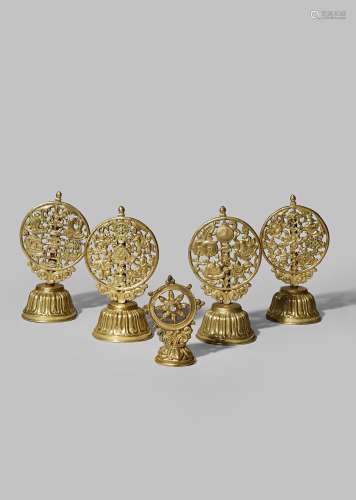 FIVE TIBETAN GILT COPPER BUDDHIST EMBLEMS 19TH CENTURY Comprising: a wheel of Dharma with a glass-