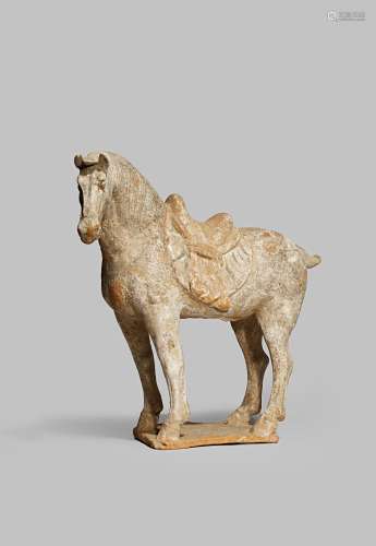 A CHINESE POTTERY MODEL OF A HORSE TANG DYNASTY 618-907 AD Standing four-square with a tiger skin
