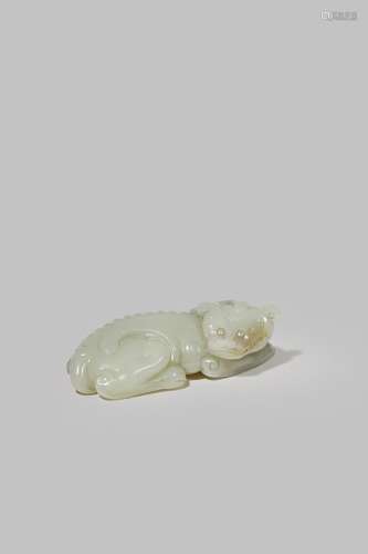 A CHINESE PALE CELADON JADE CARVING OF A QILIN 18TH CENTURY Reclining with its head turned to the