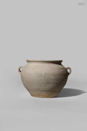 A CHINESE UNGLAZED GREY STONEWARE JAR WARRING STATES PERIOD 475-221 BC With an ovoid body and ribbed