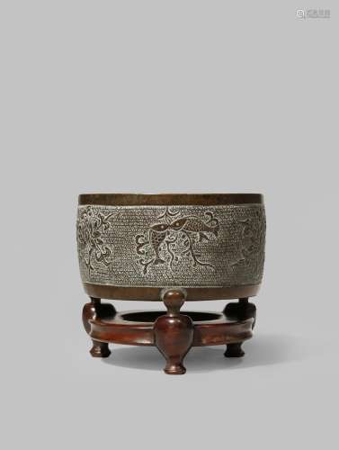 A CHINESE BRONZE TRIPOD INCENSE BURNER LATE MING DYNASTY With a cylindrical body supported on