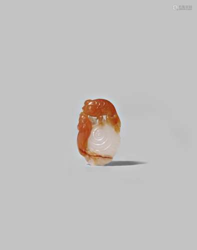 A CHINESE CARNELIAN-AGATE PENDANT QING DYNASTY OR LATER Carved as a goldfish, two snails and a leafy