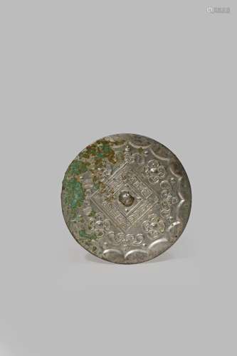 A CHINESE SILVERED BRONZE MIRROR PROBABLY TANG DYNASTY Cast in shallow relief with a central boss