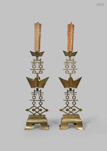 A PAIR OF CHINESE BRASS CANDLESTICKS LATE QING DYNASTY Each formed with Xi characters and ingot-