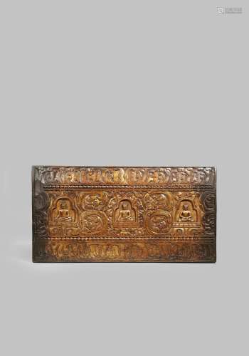 A TIBETAN CARVED WOOD BOOK COVER 19TH CENTURY OR EARLIER Gilded and carved in shallow relief with