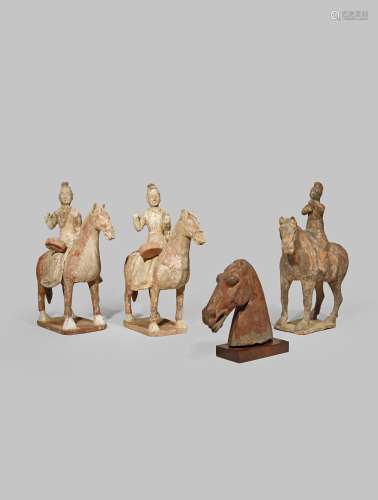 THREE CHINESE POTTERY MODELS OF HORSES AND RIDERS TANG DYNASTY OR LATER The riders wearing white