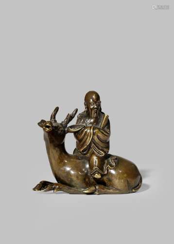 A CHINESE BRONZE WATER DROPPER LATE MING DYNASTY Formed as Shoulao seated on a recumbent deer, the