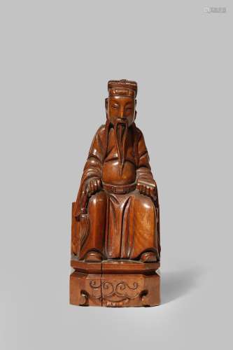 A CHINESE BOXWOOD CARVING OF A SCHOLAR QING DYNASTY Wearing flowing robes, seated on a high chair,