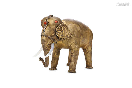 A GILT METAL ELEPHANT. 19th / 20th Century. Standing four-square with the head slightly lowered,