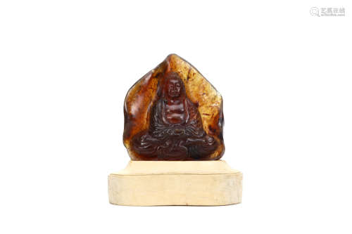 A CARVED AMBER ‘BUDDHA’ PLAQUE. 20th Century. Deeply carved with a seated Buddha in flowing robes,