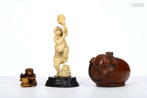 THREE OKIMONO. Meiji period. An ivory figure of Gama sennin standing holding a large toad, 12cm H, a