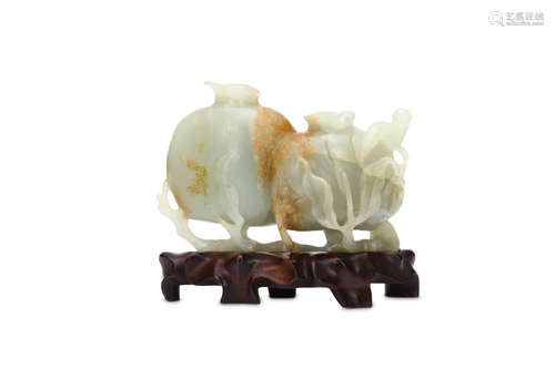 A CARVED CHINESE JADE POMEGRANATE GROUP. Qing Dynasty. Carved as two fruit born on a leafy branch,