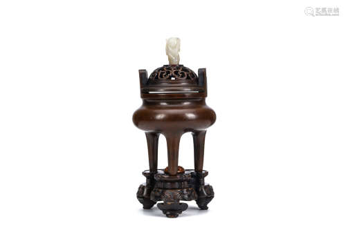 A CHINESE BRONZE TRIPOD CENSER. Early Qing Dynasty. The compressed globular body with a waisted neck
