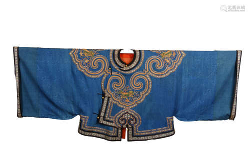 A CHINESE BLUE GROUND DAMASK JACKET. Late Qing Dynasty. The neck bordered with four large ruyi heads