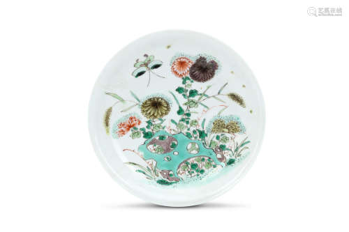 A CHINESE WUCAI DISH. Qing Dynasty, Kangxi era. The interior painted with peonies emerging from