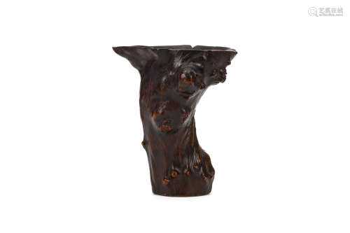 A CHINESE GNARLED TRUNK LIBATION CUP. Qing Dynasty. The twisted body rising to a spreading neck,