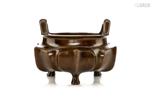 A CHINESE BRONZE TRIPOD CENSER. Qing Dynasty, 18th Century. The body formed with an irregular