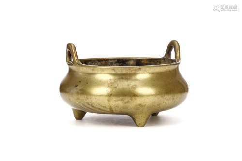 A CHINESE BRONZE CENSER. Qing Dynasty. The compressed globular body supported by three conical feet,