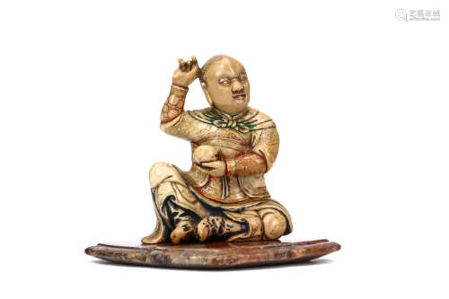 A CHINESE SOAPSTONE SEATED FIGURE AND STAND. Early Qing Dynasty. Seated with the feet touching,