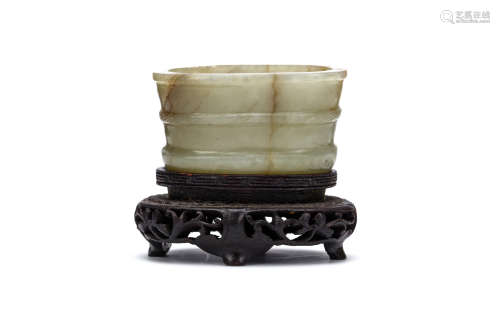 A CHINESE JADE WASHER. Qing Dynasty. Of oval section, with a raised band on the lip and at the foot,
