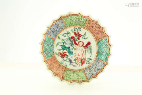 A CHINESE FAMILLE ROSE ‘CHERRUBS FOLIATE RIM TEACUP AND SAUCER, A FIGURATIVE SCENE TEACUP AND