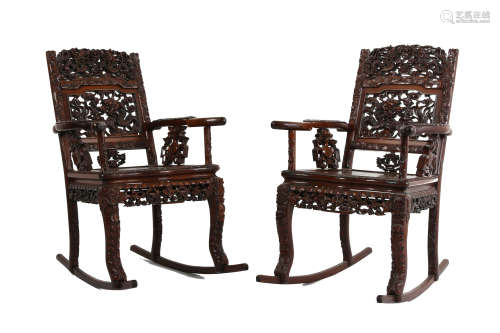 A PAIR OF CHINESE HONGMU ROCKING ARM CHAIRS. 19th / 20th Century. The central panel carved and