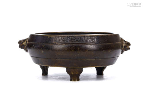 A CHINESE BRONZE TRIPOD CENSER. Qing Dynasty. The body of compressed barrel shape supported on three