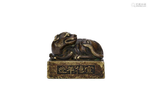 A CHINESE BRONZE WEIGHT. Ming Dynasty. Cast as a seated qilin the head turned to the left, the