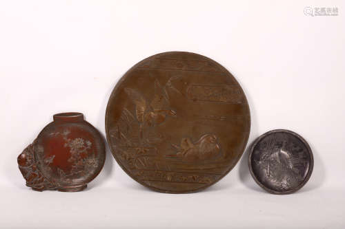 THREE SPELTER DISHES. Meiji period. Circular form with various designs, in high relief with a pair