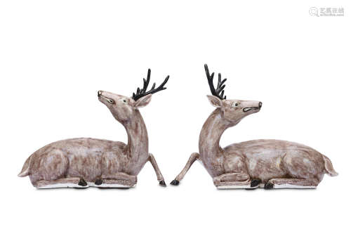 A PAIR OF CHINESE FAMILLE ROSE MODELS OF DEER. Qing Dynasty, 19th Century. Each modelled seating