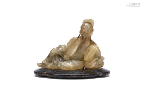 A CHINESE SOAPSTONE CARVING OF A SAGE. Qing Dynasty, 18th Century. The bearded figure seated