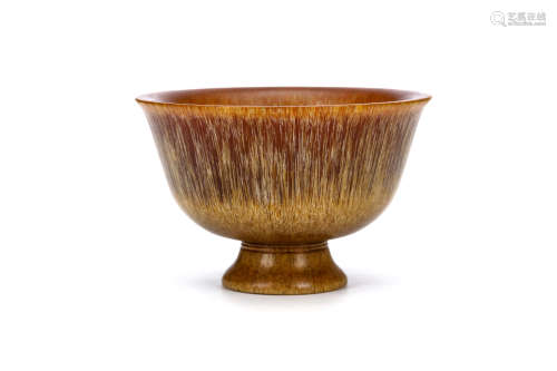 A CARVED CHINESE RHINOCEROS HORN STEM BOWL. Qing Dynasty. The steep rounded sides rising to an