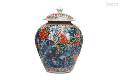 A CHINESE WUCAI JAR AND COVER. Transitional era. Painted with bamboo and peony flowers emerging from