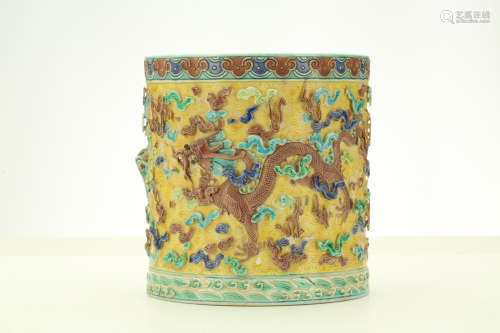 A CHINESE BISCUIT ‘DRAGON’ BRUSHPOT. Late Qing Dynasty. Decorated in high relief with three