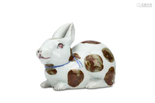 A PORCELAIN OKIMONO OF A HARE. 20th century. Decorated with circle marks in iron enamel, the