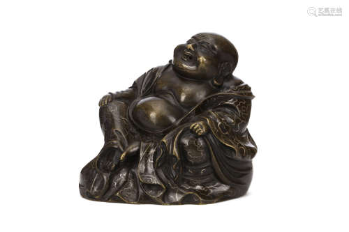 A SILVER INLAID BRONZE BUDDHA. 19th Century. Seated against a bulging sack, the belly open, in