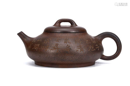 A CHINESE YIXING ZESHA TEAPOT AND COVER. Of compressed form, carved to one side with an