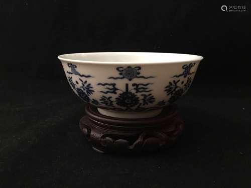A BLUE AND WHITE BOWL WITH WOOD STAND