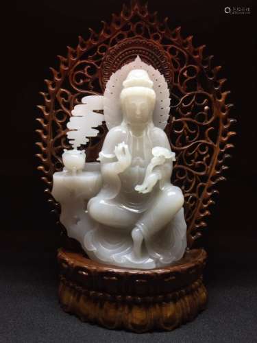 A JADE FIGURE OF GUANYIN AND WOOD STAND