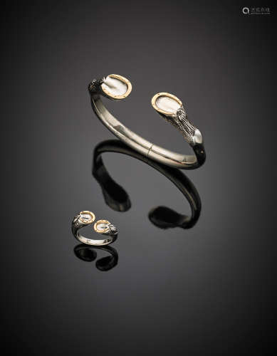 GUCCISilver and yellow gold demi parure comprising bangle and ring with a hoof motif, g 65.84. Signed GUCCI