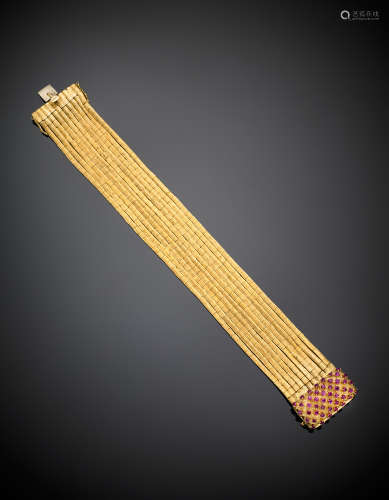 Ten strand partly glazed yellow gold bracelet with pink corundums on the clasp, g 69.34, length cm 20, h cm 2.70 circa.