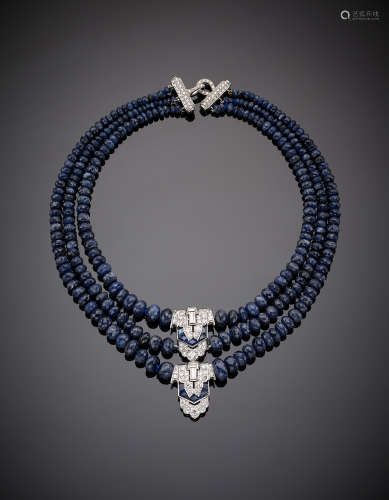 Three-strand graduated and faceted sapphire bead necklace with white gold round and baguette diamond and carré sapphire set central and clasp, g 138.10, length cm 40.50, h cm 6.00 circa.