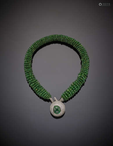 MARTINELLIInterwoven emerald bead necklace with diamond set white gold clasp, in all ct. 8.60 circa centered by a cabochon emerald ct. 7.9 circa, g 118.5, length cm 44 circa. Signed MARTINELLI