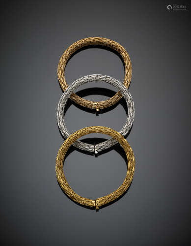 Three braided mesh bracelets in yellow, white and pink gold, in all g 97.4, length cm 19.3 circa.