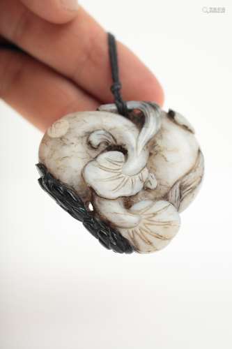 A Chinese black and white jade pendant,
