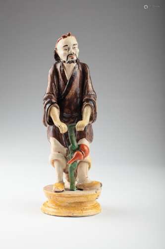 An old Chinese Shiwan figure of a traveller,